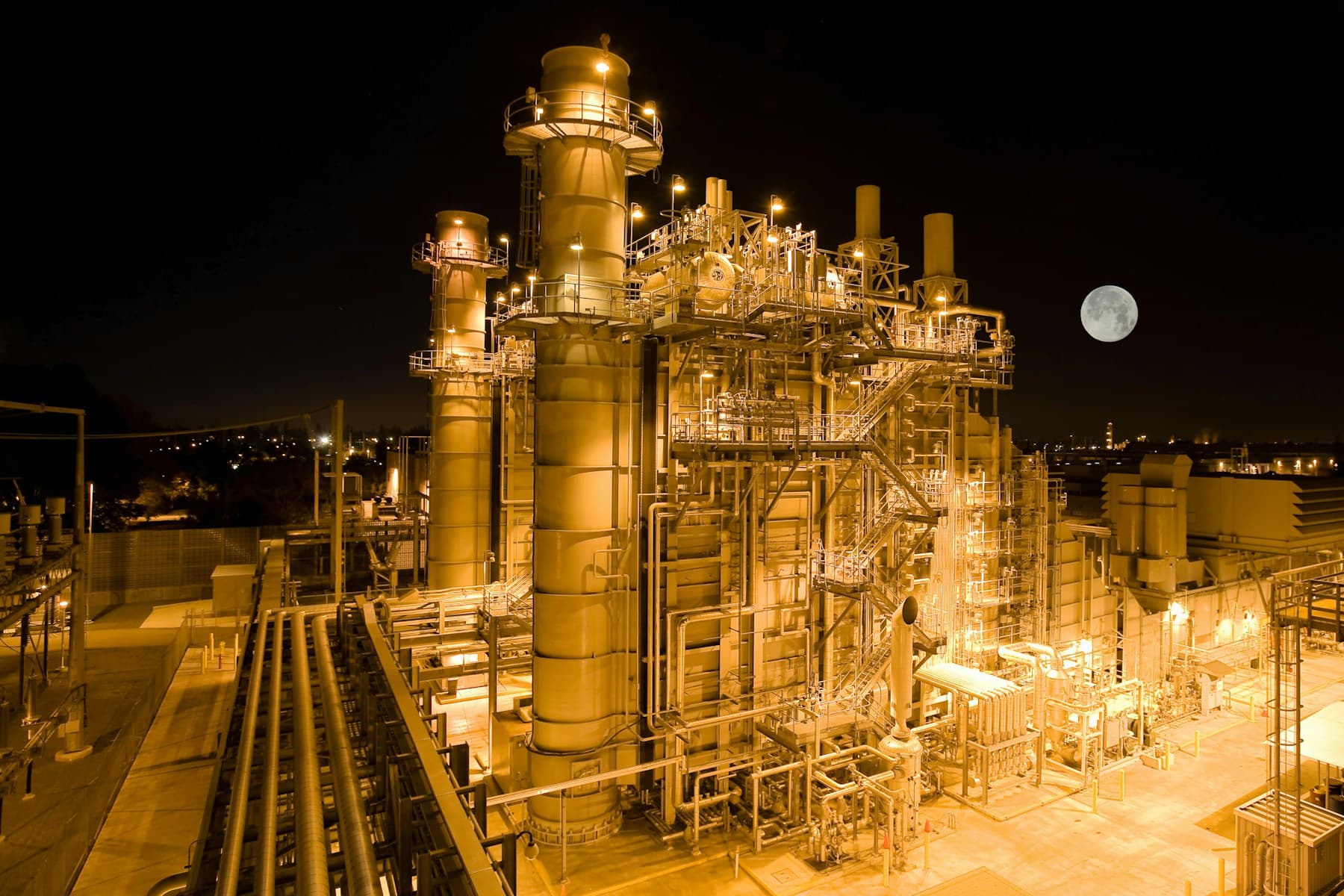 Combined-cycle power plant illuminated at night